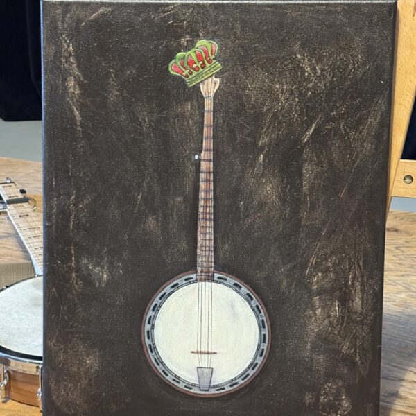 Resonator Banjo Painting A photo of Stephanie Belinda Quinn's banjo painting, King of Bluegrass, beside a banjo.